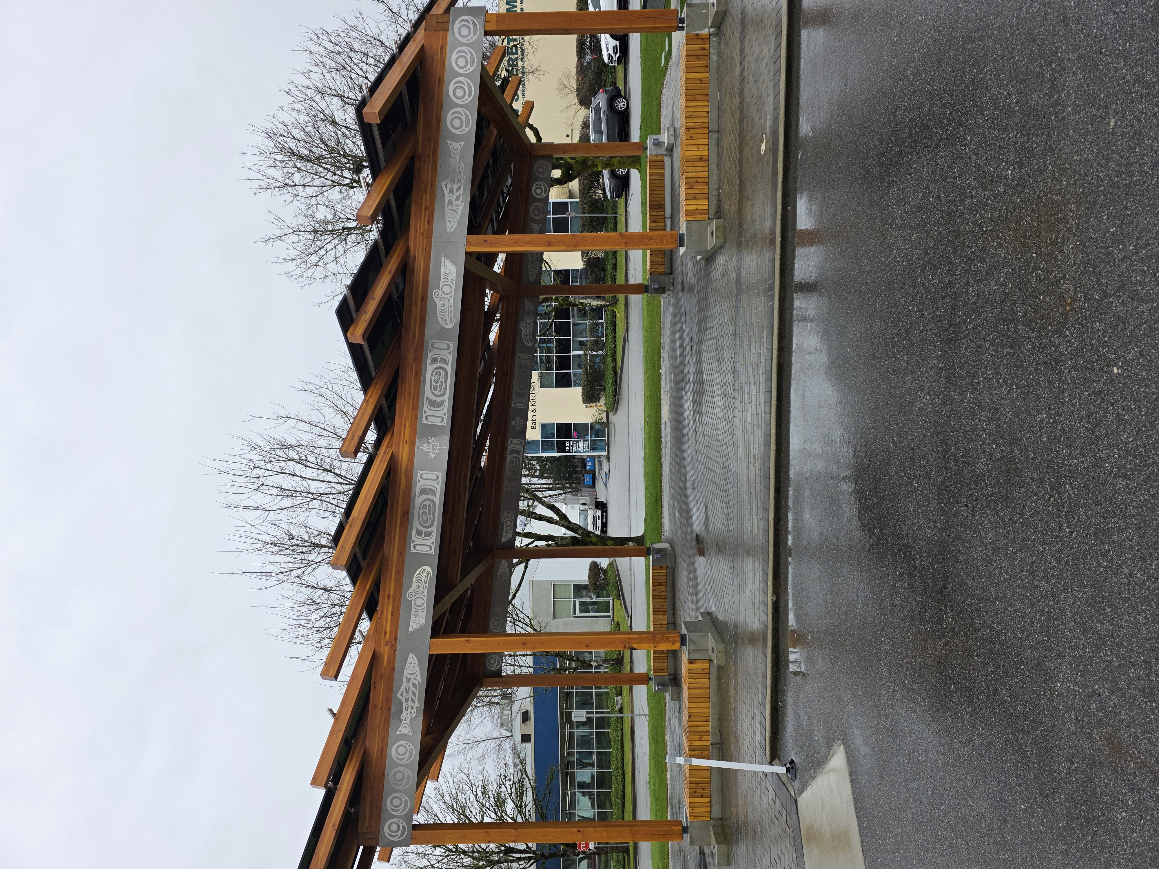 George Ingham Plaza timber pavilion with seating area and open roof structure in EJTC Port Coquitlam campus
